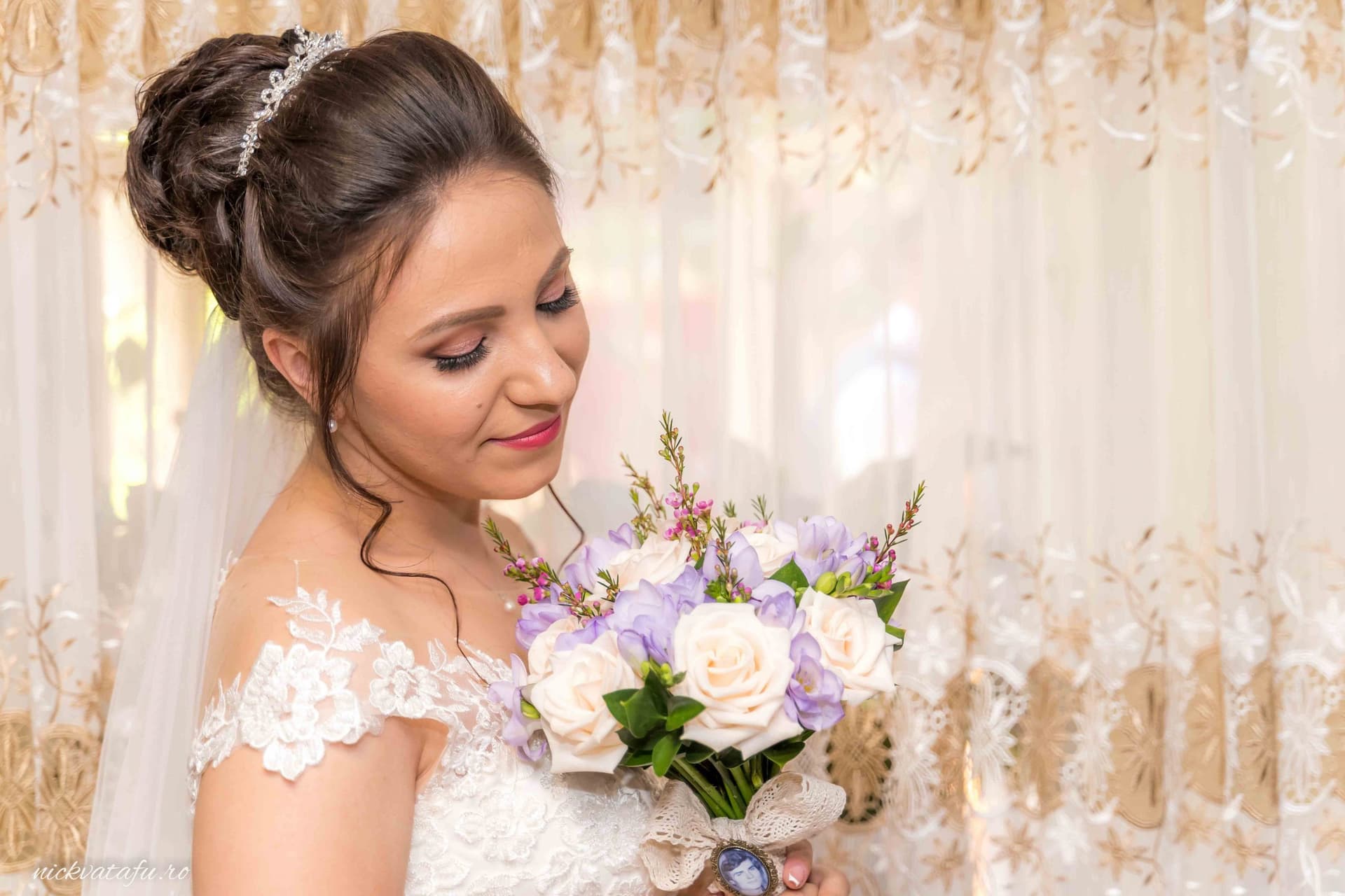 Mireasă zâmbitoare, admirând buchetul de flori, detalii elegante pentru o fotografie de nuntă.