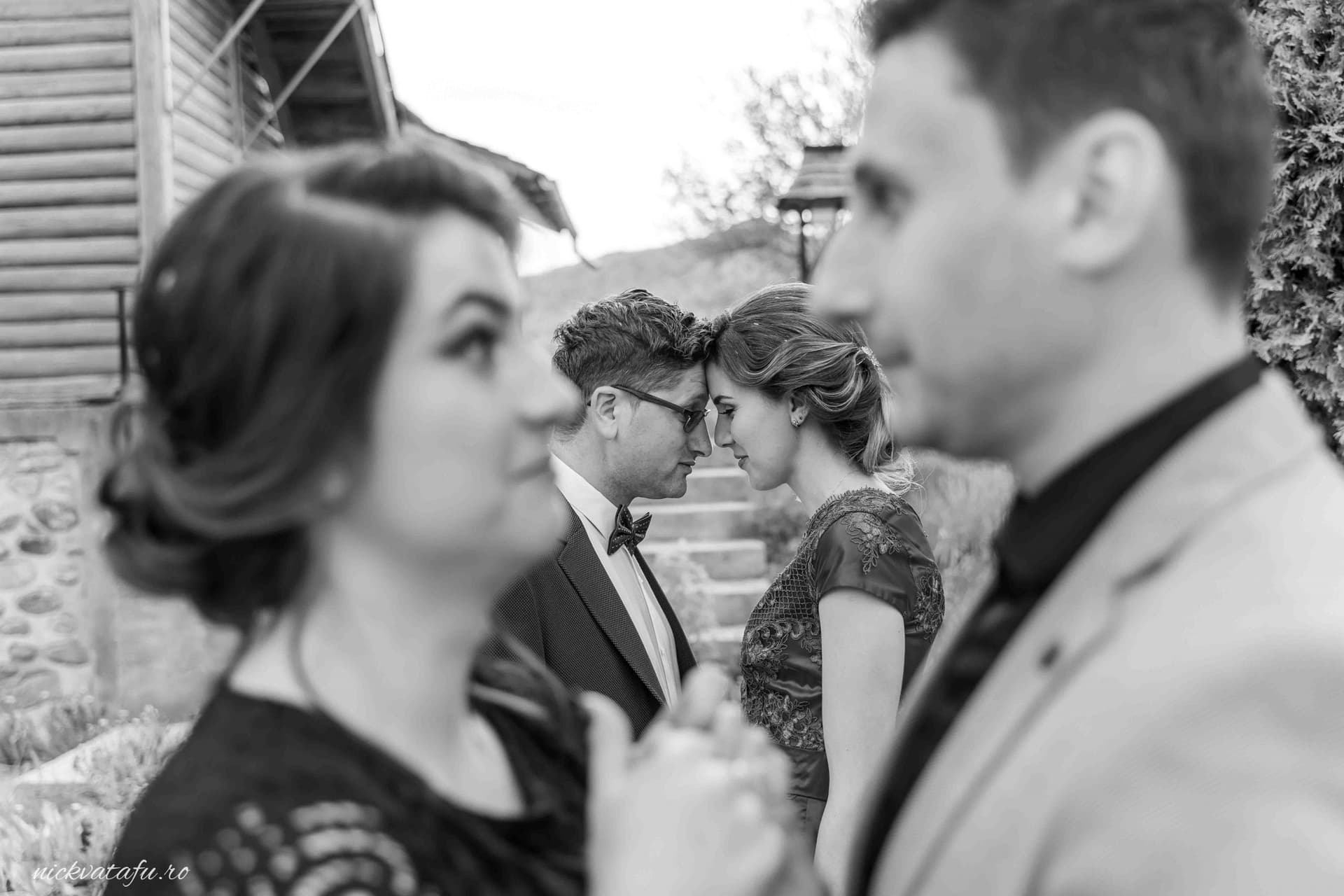 Cupluri îmbrăcate elegant, privindu-se cu intensitate, surprinse într-un moment de conexiune emoțională la un eveniment special.